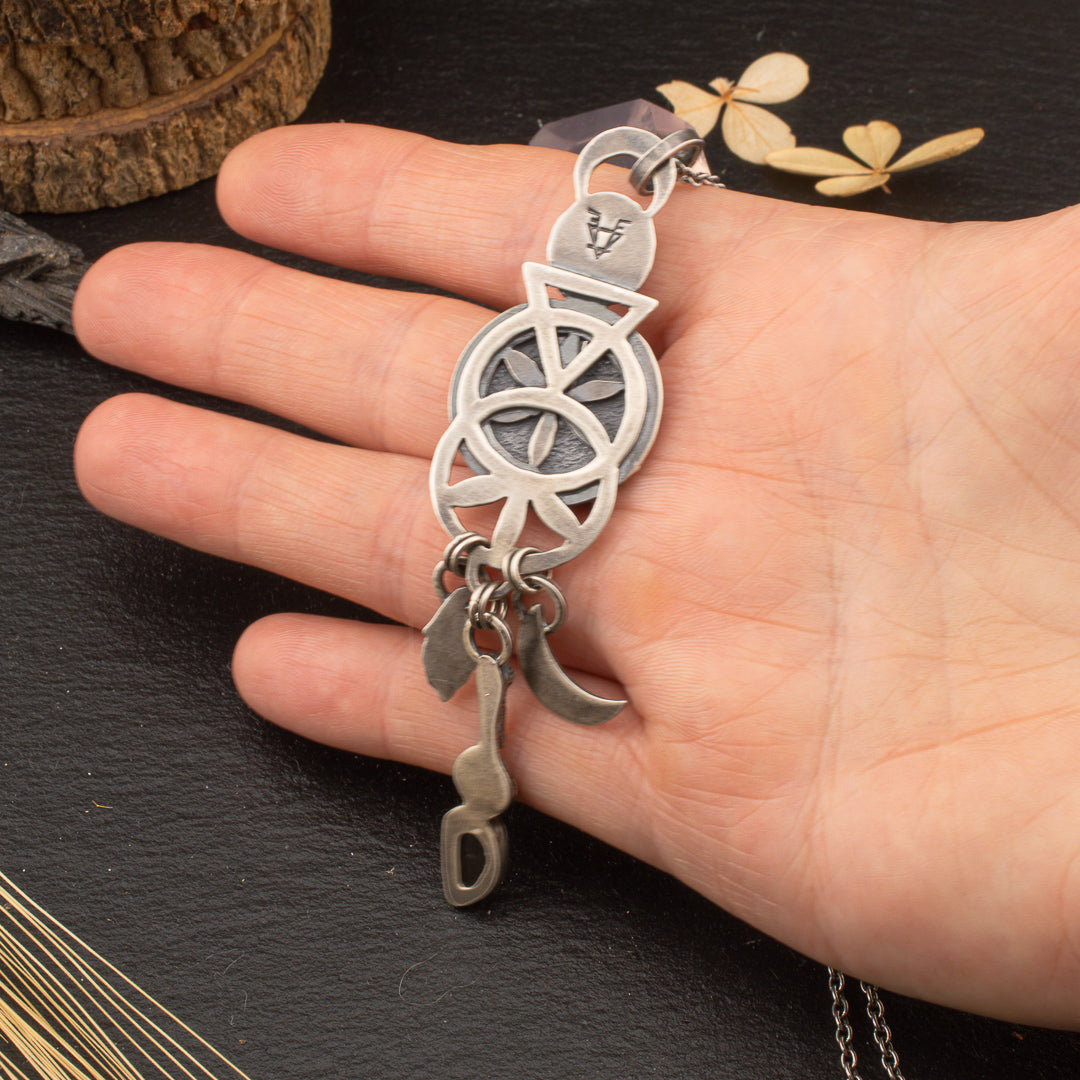 Back detail of sterling silver pendant with pirced sacred geometry sigil showing.