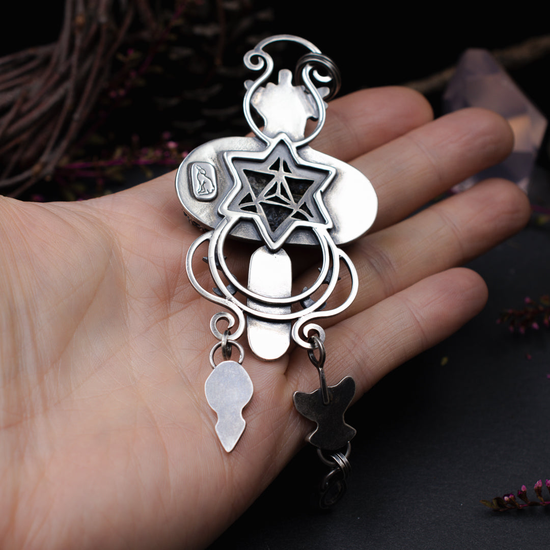 Close up of the merkaba pierced into the silver back plate of this talisman.