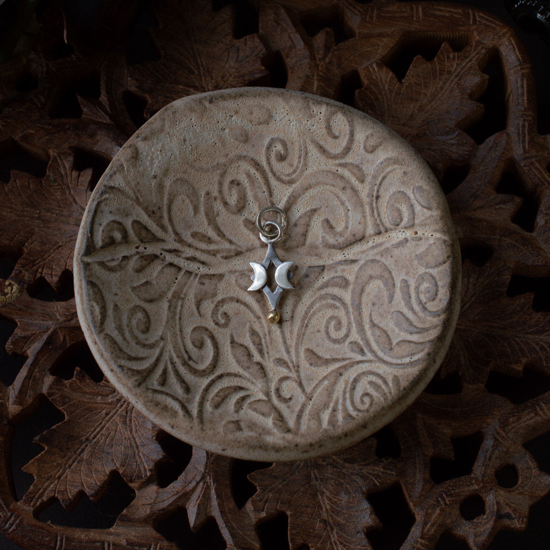 Small sterling silver diamond charm with two crescent moons.