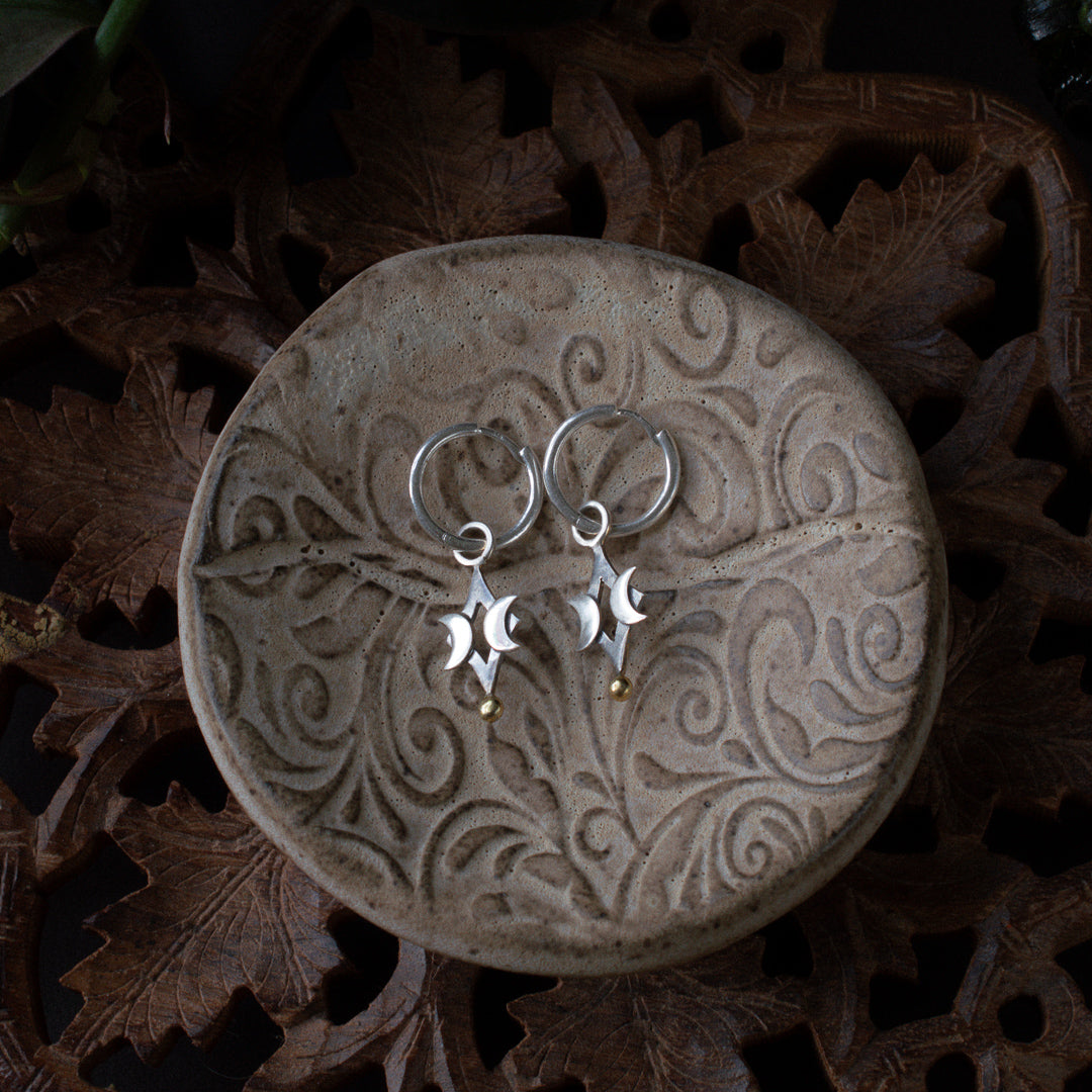 Witchy hoop earrings with diamond and crescent moon charms.