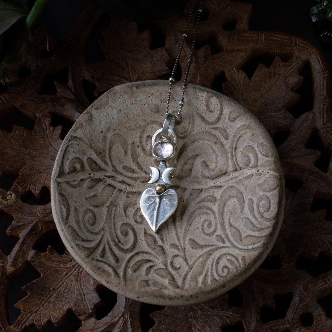 Delicate sterling silver necklace featuring a natural leaf and pink tourmaline.