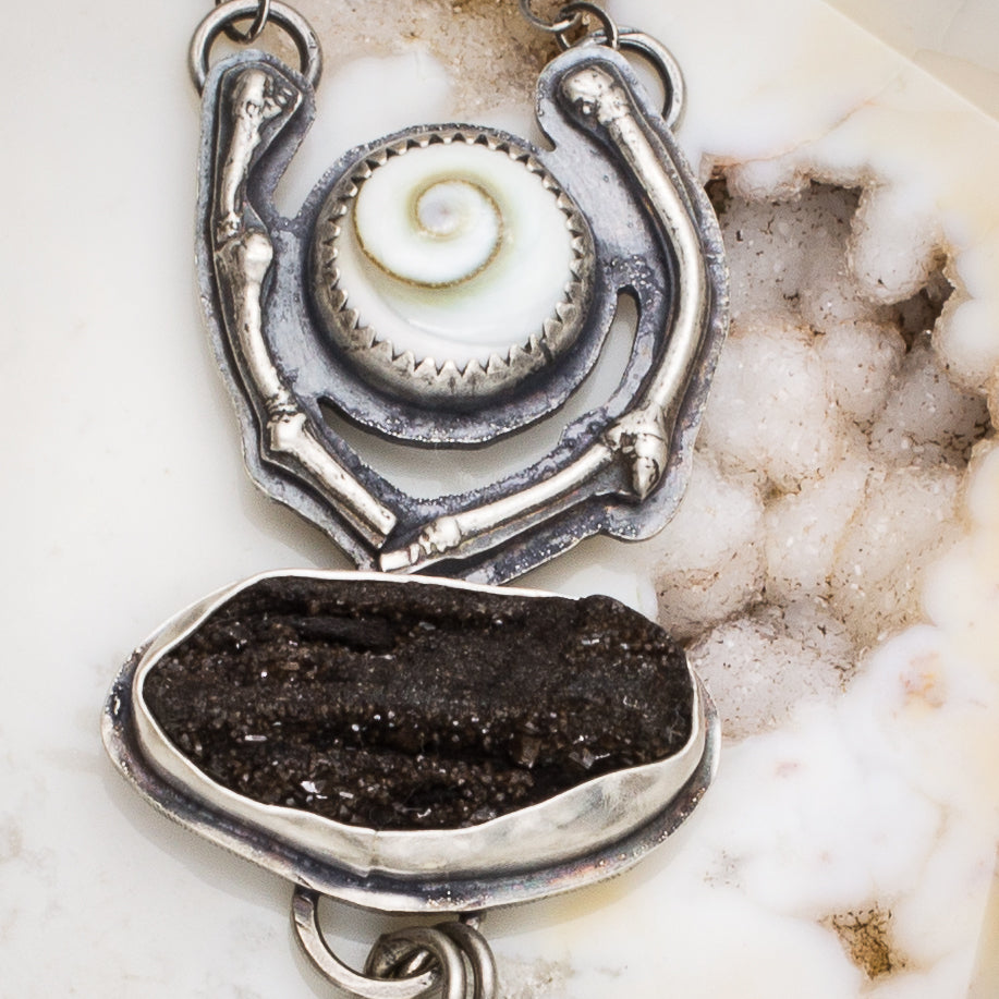 Close up of cast sterling silver bnranch detail and set shiva shell and druzy petrified wood.