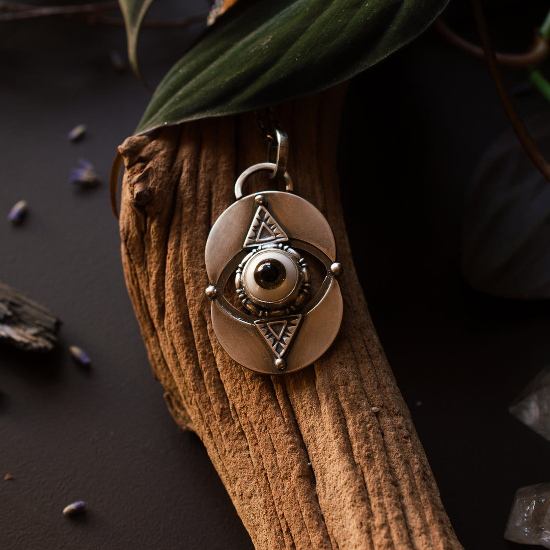 Brown glass eye sterling silver talisman necklace.