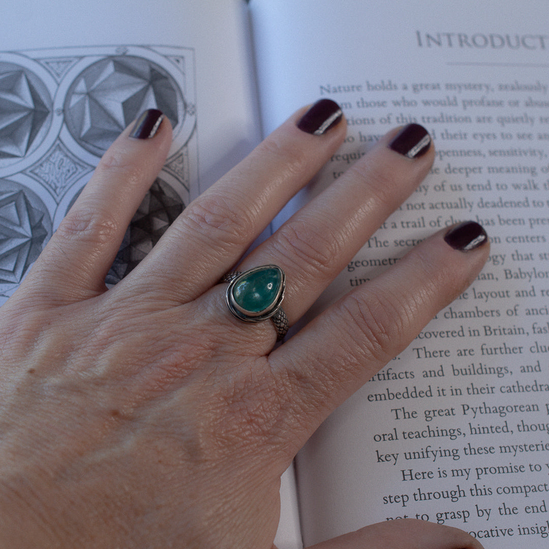 Hand wearing a beautiful aqua kyanite tear drop shaped cocktail ring.