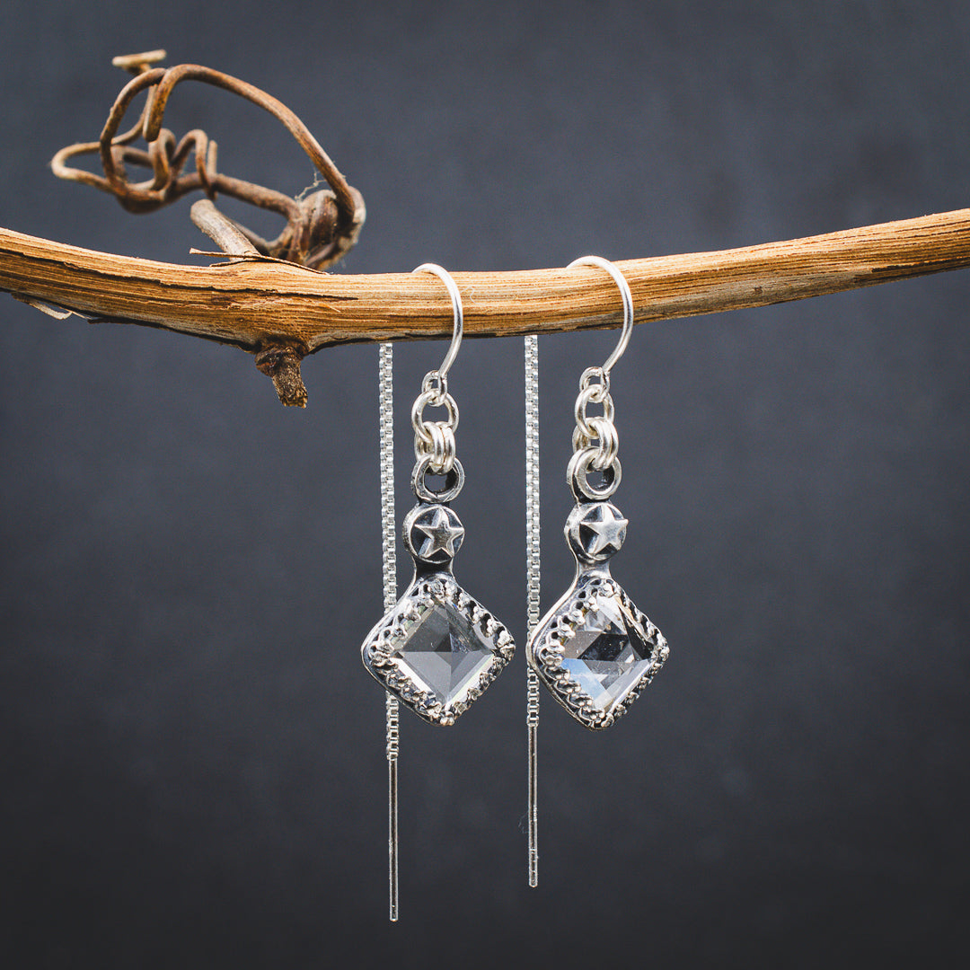 Hand cut clear quartz ear threader earrings with star details.