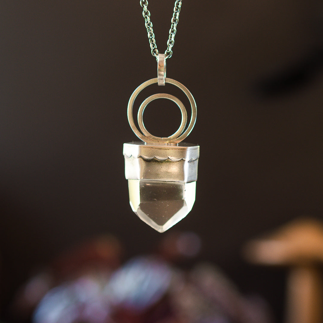 Chunky polished clear quartz point set in sterling silver.