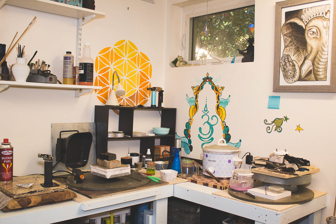 Flower of life and the Sanskrit symbol for breathe painted on a wall surrounding a soldering station.