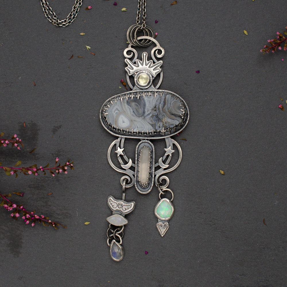 Desert druzy talisman set in sterling silver with crescent moons and stars.