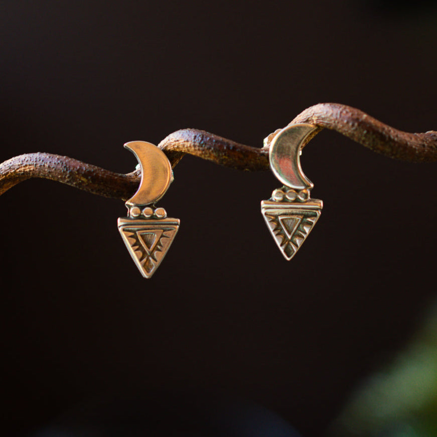 A pair of sterling silver stamped crescent moon stud earrings.