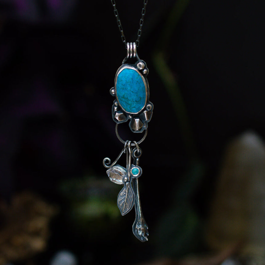 Turquoise sterling silver pendant with Herkimer diamond and cast leaf dangles.